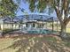 Screened pool with a backyard view, and trees providing shade at 205 Minniehaha Cir, Haines City, FL 33844