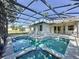 Beautiful screened pool with an attached spa and sun shelf, perfect for relaxation at 205 Minniehaha Cir, Haines City, FL 33844