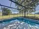 Sparkling screened pool with a sun shelf, attached spa, and large backyard at 205 Minniehaha Cir, Haines City, FL 33844