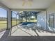 Beautiful screened pool area featuring a tranquil spa and serene backyard view at 205 Minniehaha Cir, Haines City, FL 33844