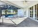 Backyard pool with screened enclosure, ceiling fan and sliding glass doors to home at 205 Minniehaha Cir, Haines City, FL 33844