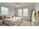 Bright bedroom features plush carpet, a ceiling fan, and plenty of natural light from the windows at 2943 Sunstar Dr, St Cloud, FL 34772