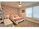 Bedroom features colorful wallpaper and large windows at 2943 Sunstar Dr, St Cloud, FL 34772