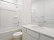 Well-lit bathroom featuring a tub and shower combo and modern fixtures at 6381 Clover St, Lake Hamilton, FL 33851