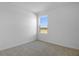 Bedroom features neutral walls, large window, and soft carpeting at 6381 Clover St, Lake Hamilton, FL 33851