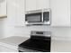 Modern kitchen featuring stainless steel appliances and white countertops at 6381 Clover St, Lake Hamilton, FL 33851