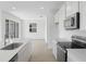 Open-concept kitchen featuring stainless steel appliances and a view of the living area at 6381 Clover St, Lake Hamilton, FL 33851