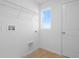 Laundry room features tile flooring, shelving, and large window at 6381 Clover St, Lake Hamilton, FL 33851