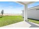 Back yard with concrete patio and grassy yard and view of neighborhood beyond property line at 6393 Clover St, Lake Hamilton, FL 33851