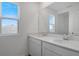 Bathroom featuring a double vanity with quartz countertops and modern fixtures and mirror at 6393 Clover St, Lake Hamilton, FL 33851