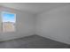 Light, bright bedroom featuring neutral walls and soft carpet under a sunny window at 6393 Clover St, Lake Hamilton, FL 33851