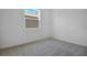 Clean bedroom with neutral carpeting and a bright sunny window at 6393 Clover St, Lake Hamilton, FL 33851