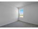 Bright bedroom with plush carpeting and a window offering natural light and green fields at 6393 Clover St, Lake Hamilton, FL 33851