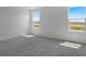 Sun-filled bedroom featuring neutral walls and soft carpet under two sunny windows at 6393 Clover St, Lake Hamilton, FL 33851