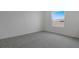 Bright bedroom with plush carpeting and a large window offering natural light at 6393 Clover St, Lake Hamilton, FL 33851