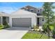 Charming two-story home featuring a gray exterior, well-maintained lawn and a two car garage at 6393 Clover St, Lake Hamilton, FL 33851