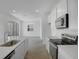 Modern kitchen with stainless steel appliances, white cabinets, and access to living area at 6393 Clover St, Lake Hamilton, FL 33851