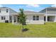 The backyard showcases a new lawn and views of neighboring homes creating a modern residential aesthetic at 6397 Clover St, Lake Hamilton, FL 33851
