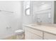 Clean bathroom featuring a toilet and vanity with countertop and mirror, and a shower in the mirror reflection at 6397 Clover St, Lake Hamilton, FL 33851