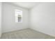 Carpeted bedroom with a neutral color scheme and a window providing natural light at 6397 Clover St, Lake Hamilton, FL 33851
