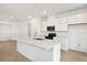 Modern kitchen features white cabinetry, stainless steel appliances, and a spacious center island at 6397 Clover St, Lake Hamilton, FL 33851