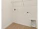 Neat laundry area with hookups, tile floors, and shelf for storage solutions at 6397 Clover St, Lake Hamilton, FL 33851