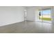 Bright living area with tile flooring, a sliding glass door, and neutral walls for a modern feel at 6397 Clover St, Lake Hamilton, FL 33851