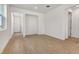 Bright living room featuring wood-look tile floors and neutral white walls with an open floor plan at 6397 Clover St, Lake Hamilton, FL 33851