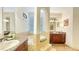 Luxurious bathroom featuring a soaking tub, double vanity, and tile accents at 1251 Radiant St, Reunion, FL 34747