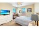 Charming bedroom with a TV, crib, and cozy bedding at 1251 Radiant St, Reunion, FL 34747