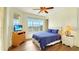 Comfortable bedroom features hardwood floors, lots of natural light, and a ceiling fan at 1251 Radiant St, Reunion, FL 34747