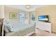 Bright bedroom with a dresser, TV, and cozy bedding for a relaxing retreat at 1251 Radiant St, Reunion, FL 34747