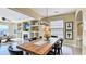 Bright dining room features a fireplace, built-in shelves, and a large wooden table with black chairs at 1251 Radiant St, Reunion, FL 34747