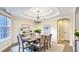 Elegant dining room featuring a tray ceiling, chandelier, and tastefully decorated table setting at 1251 Radiant St, Reunion, FL 34747