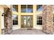 Stunning front entrance with stone columns and large windows at 1251 Radiant St, Reunion, FL 34747