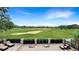 Expansive golf course view from the patio with outdoor furniture and a well-manicured lawn at 1251 Radiant St, Reunion, FL 34747