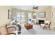 Bright living room with a fireplace, neutral decor, and sliding glass doors to the balcony at 1251 Radiant St, Reunion, FL 34747