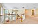 Bright upstairs loft area with carpeting, decorative lighting, and an overlook to the floor below at 1251 Radiant St, Reunion, FL 34747