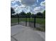 A fenced community dog park with lush green grass, a gate, and a concrete pathway in a pet-friendly neighborhood at 1907 Partin Terrace Rd, Kissimmee, FL 34744