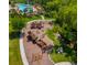Aerial view of the community playground with multiple play structures and a swimming pool in the background at 1907 Partin Terrace Rd, Kissimmee, FL 34744
