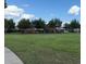 A community playground with play structures surrounded by lush green grass, perfect for outdoor activities at 1907 Partin Terrace Rd, Kissimmee, FL 34744