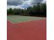 Community tennis court featuring a vibrant red and green surface, perfect for recreational play and exercise at 1907 Partin Terrace Rd, Kissimmee, FL 34744