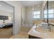 Bathroom with tub/shower combo with glass doors, and granite vanity with sink at 2618 Roadster Ln, Kissimmee, FL 34746
