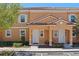 Charming townhome featuring a stucco facade, tiled roof, and well-manicured landscaping, unit #2620 at 2618 Roadster Ln, Kissimmee, FL 34746
