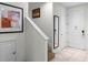 Bright hallway featuring stairs, tiled floor, framed art, and white doors leading to different areas at 2618 Roadster Ln, Kissimmee, FL 34746