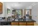 Open-concept kitchen boasts an island with sink, granite countertops, and backyard access at 2618 Roadster Ln, Kissimmee, FL 34746