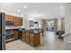 Open-concept kitchen boasts an island with sink, granite countertops, and backyard access at 2618 Roadster Ln, Kissimmee, FL 34746