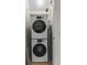 Compact laundry closet with stacked washer and dryer, maximizing space efficiency at 2618 Roadster Ln, Kissimmee, FL 34746