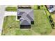Aerial view of home with architectural shingle roof and spacious yard, perfect for outdoor living at 308 Miami Ln, Kissimmee, FL 34759