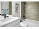 Bathroom featuring sleek black fixtures, a bathtub with tile surround, and a quartz countertop at 308 Miami Ln, Kissimmee, FL 34759